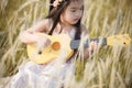 Child playing guitar to meadow outdoor in nature Royalty Free Stock Photo