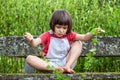 Child playing with ivy stems to learn nature in garden
