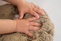 Child playing with kinetic sand. Baby`s sensory experiences