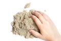 Child playing with kinetic sand. Hand of the child in the sand c