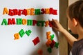 the child is playing with the letters of alphabet. Intellectual play, preschool primary education Royalty Free Stock Photo