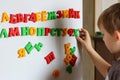 the child is playing with the letters of alphabet. Intellectual play, preschool primary education Royalty Free Stock Photo