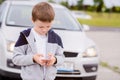 Child playing mobile games on smartphone on the street