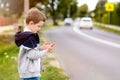 Child playing mobile games on smartphone on the street