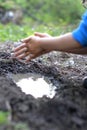 Child playing with mud - blur hands for focus on pond Royalty Free Stock Photo