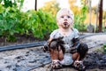child playing in the mud on the street Royalty Free Stock Photo