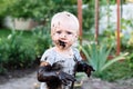 Child playing in the mud on the street Royalty Free Stock Photo