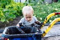 Child playing in the mud on the street Royalty Free Stock Photo