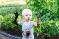 Child playing in the mud on the street Royalty Free Stock Photo