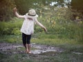 A child playing in a muddy puddle. Royalty Free Stock Photo