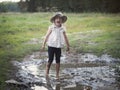 A child playing in a muddy puddle. Royalty Free Stock Photo