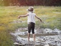 A child playing in a muddy puddle. Royalty Free Stock Photo