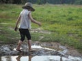 A child playing in a muddy puddle. Royalty Free Stock Photo