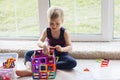 The child is playing with a multi-colored magnetic constructor, building a tower. Educational toys . A building block for a baby Royalty Free Stock Photo