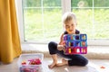 The child is playing with a multi-colored magnetic constructor, building a tower. Educational toys . A building block for a baby Royalty Free Stock Photo