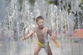 Child playing in a musical fountain