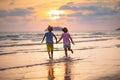 Child playing on ocean beach. Kid at sunset sea Royalty Free Stock Photo