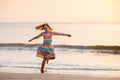 Child playing on ocean beach. Kid at sunset sea Royalty Free Stock Photo