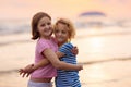 Child playing on ocean beach. Kid at sunset sea Royalty Free Stock Photo