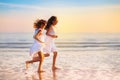 Child playing on ocean beach. Kid at sunset sea Royalty Free Stock Photo