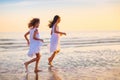 Child playing on ocean beach. Kid at sunset sea Royalty Free Stock Photo