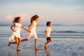 Child playing on ocean beach. Kid at sunset sea Royalty Free Stock Photo