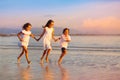 Child playing on ocean beach. Kid at sunset sea Royalty Free Stock Photo