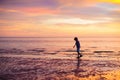 Child playing on ocean beach. Kid at sunset sea Royalty Free Stock Photo