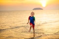 Child playing on ocean beach. Kid at sunset sea Royalty Free Stock Photo