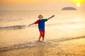 Child playing on ocean beach. Kid at sunset sea Royalty Free Stock Photo