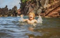 Child playing in ocean water. Kid jumping in the sea waves. Kids vacation on beach. Little excited boy swimming during Royalty Free Stock Photo