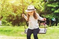 Child playing in the open playground, little happy laughing girl swinging on a swing Royalty Free Stock Photo