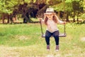 Child playing in the open playground, little happy laughing girl swinging on a swing Royalty Free Stock Photo