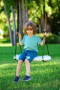 Child playing outdoor. Kids swing on backyard. Happy cute little boy swinging and having fun healthy summer vacation Royalty Free Stock Photo