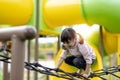 Child playing on outdoor playground. Kids play on school or kindergarten yard. Active kid on colorful slide and swing. Healthy Royalty Free Stock Photo