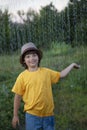 Child playing outdoor on rainy day. Happy boy in summer rain