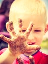 Child playing outdoor showing dirty muddy hands. Royalty Free Stock Photo