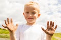 Child playing outdoor showing dirty muddy hands. Royalty Free Stock Photo