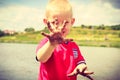 Child playing outdoor showing dirty muddy hands. Royalty Free Stock Photo
