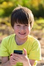 Child playing phone outdoors