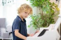 Child playing piano. Kids play music Royalty Free Stock Photo