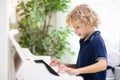 Child playing piano. Kids play music Royalty Free Stock Photo