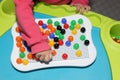 Child playing plastic colored toy mosaic on the table Royalty Free Stock Photo