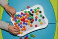 Child playing plastic colored toy mosaic on the table Royalty Free Stock Photo