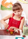 Child playing with plasticine in school.