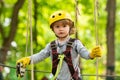 Child playing on the playground. Happy little child climbing on a rope playground outdoor. Adventure climbing high wire