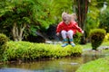 Child playing in puddle. Kids jump in autumn rain Royalty Free Stock Photo