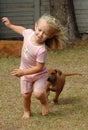Child playing with puppy