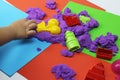 Child playing with purple kinetic sand