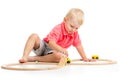 Child playing rail road toy